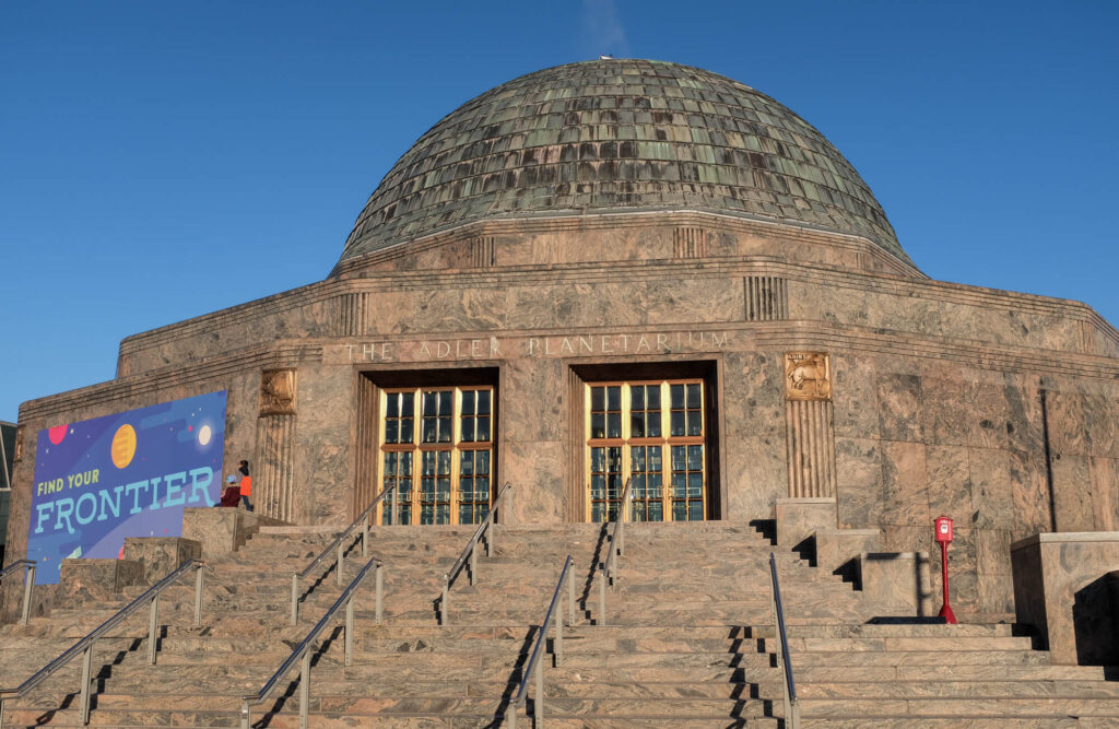 Entrance of the Adler Planetarium / Flickr / Neal Wellons

Link: https://flickr.com/photos/97423979@N00/40090232575/in/photolist-KdmU8u-245CVqt-25CeLGt-25ypwZU-25ypxTY-24xtXK3-25ypywG-25CeLbi-24xtWLQ-29hY5hg-hYTEFf-nozuwR-26oZVw1-26Zcy4q-22FKbe5-hYUaxo-npbzB2-nHsDe6-npbxeW-23S3NRA-9JNfu4-62vqGT-hYTiUg-Lunt4t-hYTkzF-hYUd2F-hYUcMH-hYUesM-hYTfwz-hYTjYR-hYTezV-hYTf1z-hYTyEY-hYTzNQ-hYTjdx-hYThcP-hYTgpX-hYTsyG-hYUdSt-hYTsjy-hYTibx-hYTtZh-hYUhgH-hYULkD-tcXYj-hYTFj9-hYUaZK-hYTm7H-hYTiEZ-hYTi2z